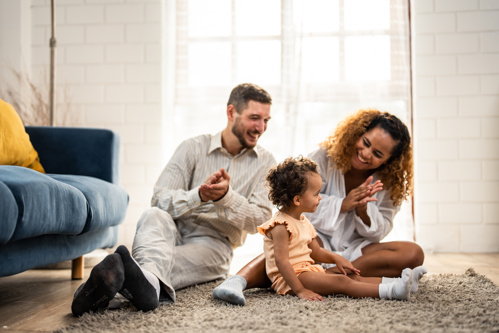 Parents playing with their daughter