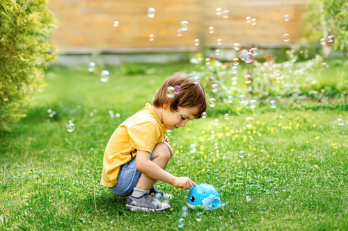 Little boy playing with bubbles