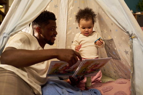 Man reading with daughter
