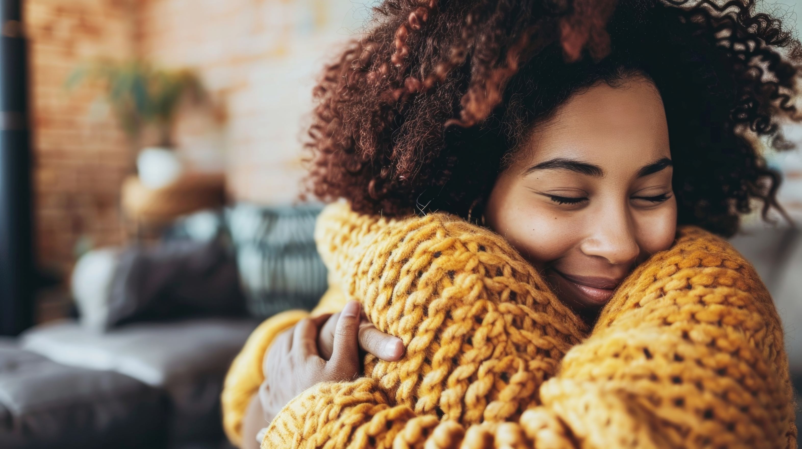 A woman smiling holding a cushion