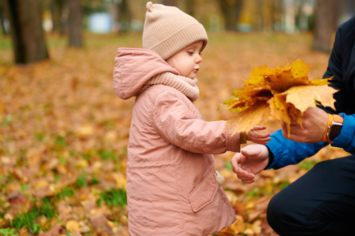 Child playing with leaves