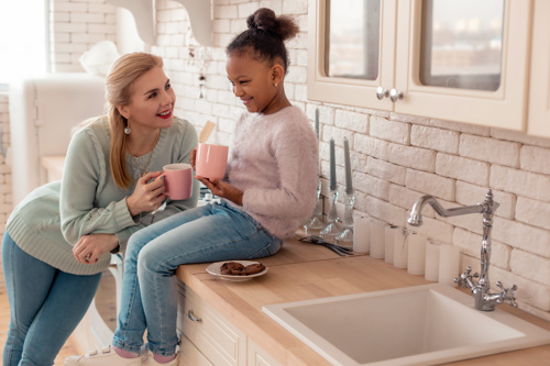 Lady talking to child in the kitchen