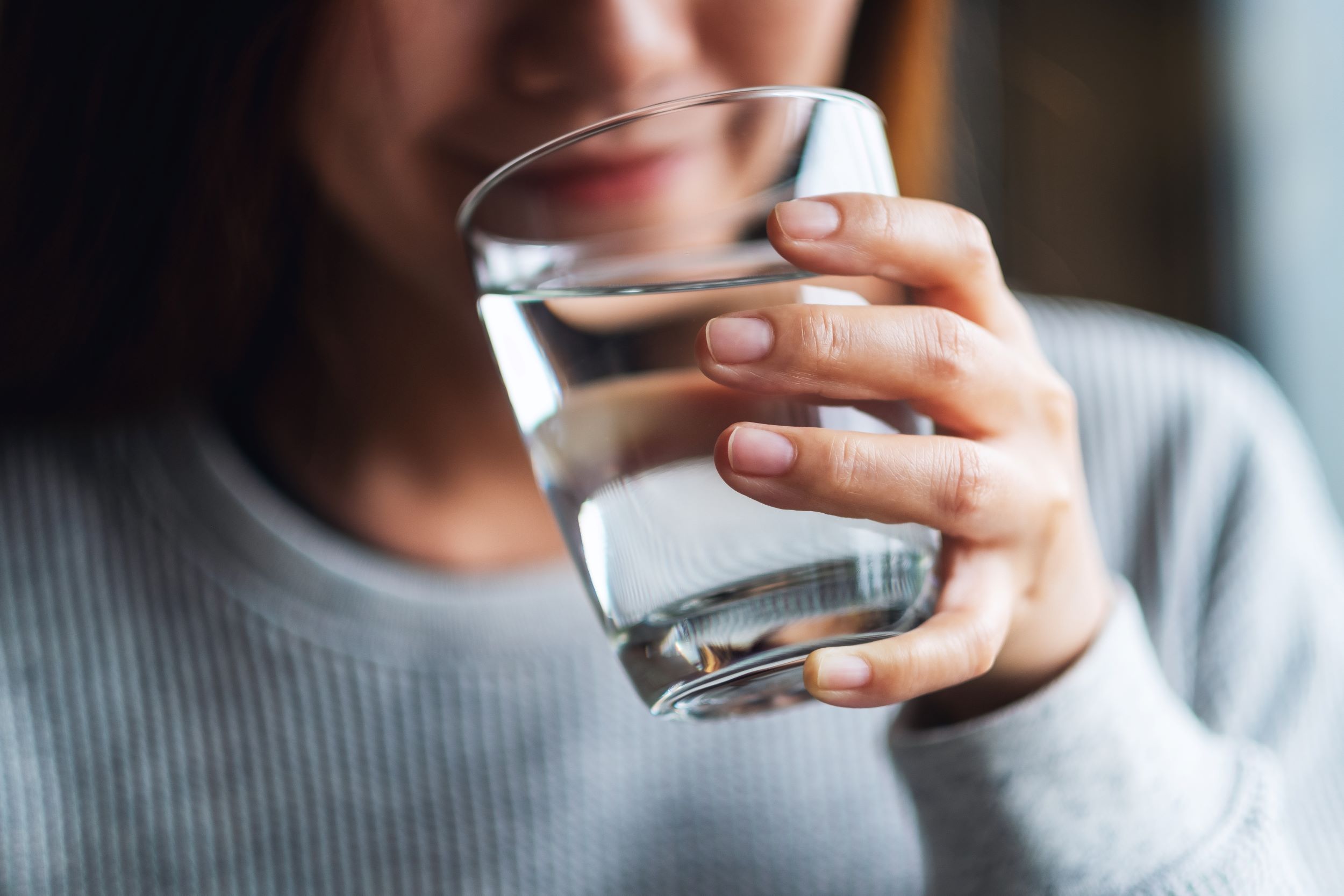 A woman drinking a glass of water