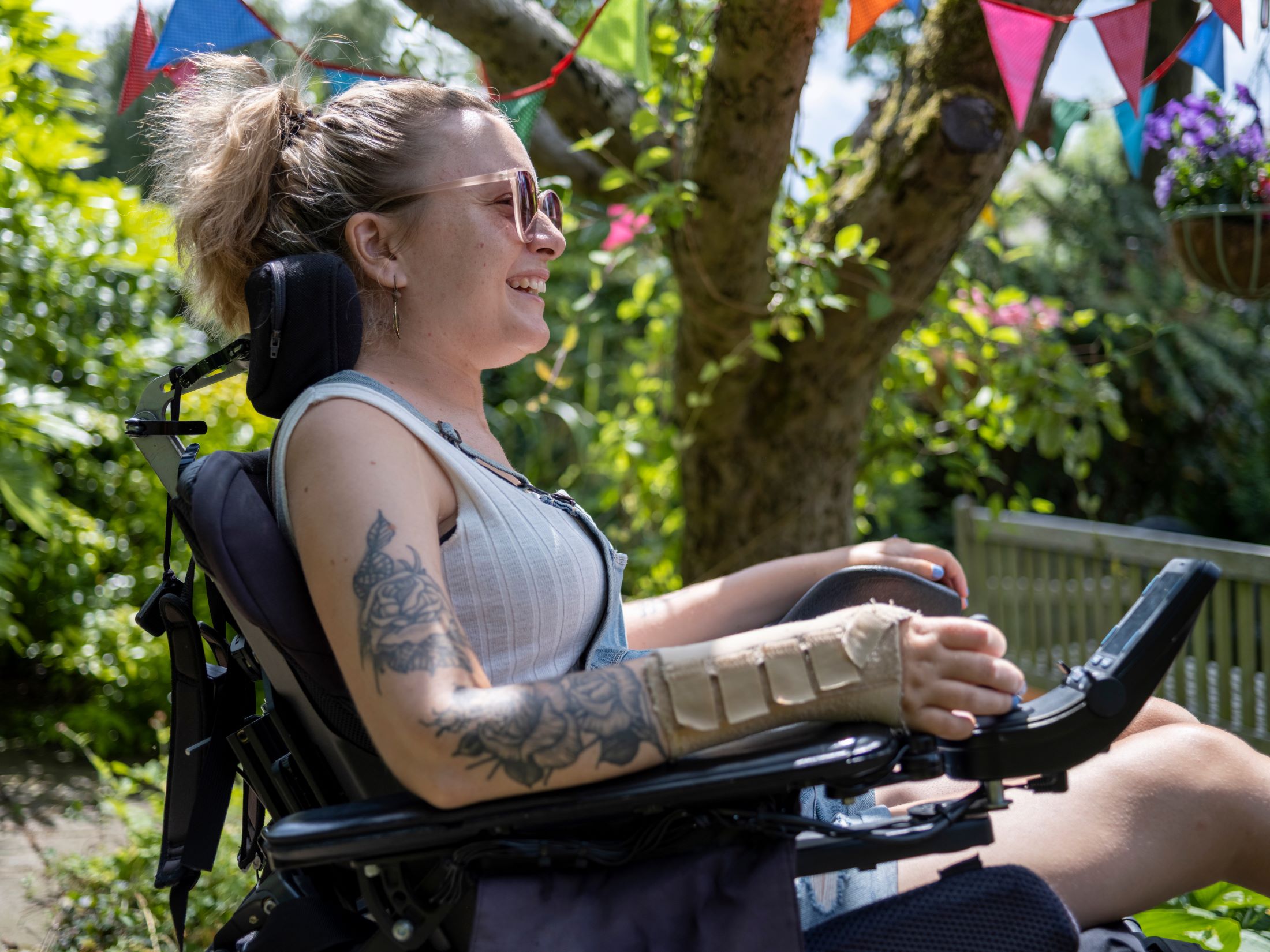 A lady smiling in a wheelchair